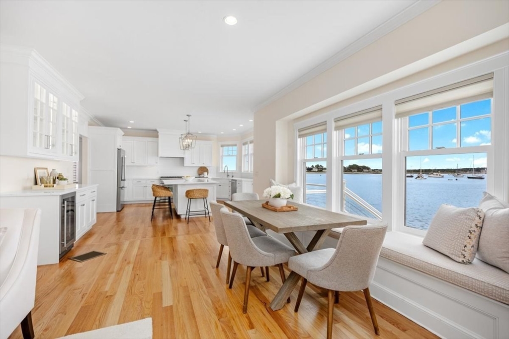 a dining room with furniture and large windows