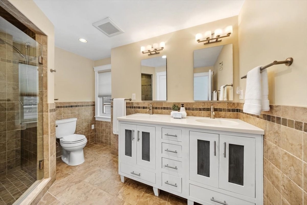 86 Lighthouse Road Scituate, MA 02066 - Photo 17 of 38 a bathroom with a double vanity sink toilet and a mirror