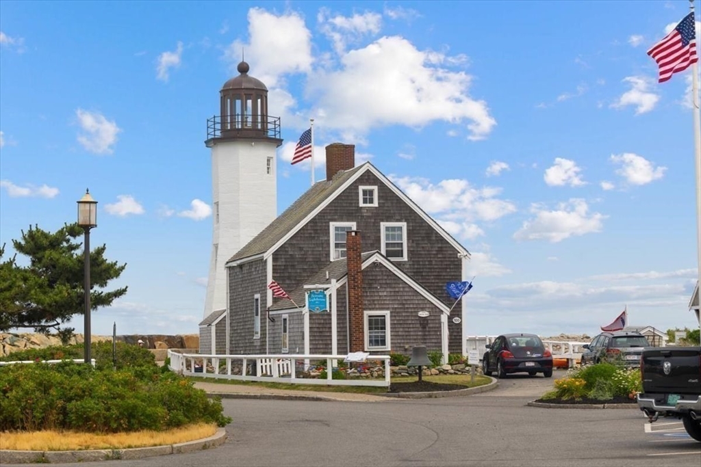 86 Lighthouse Road Scituate, MA 02066 - Photo 32 of 38 a front view of a house with a yard and garage