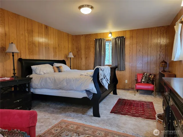 a bedroom with bed and a couch