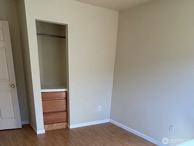 a view of an empty room and wooden floor