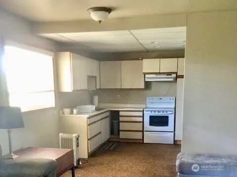 a kitchen with a sink cabinets and window