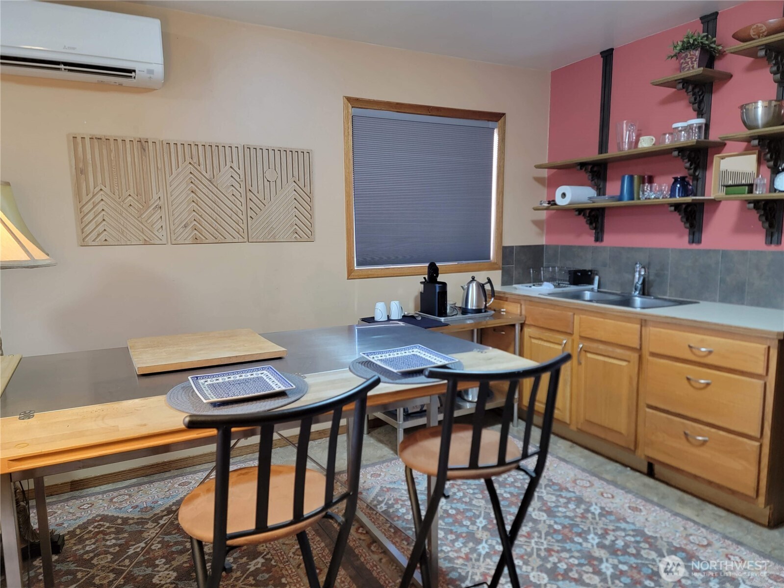 55 Gold Mountain Road Republic, WA 99166 - Photo 36 of 40 a kitchen with stainless steel appliances a table and chairs in it