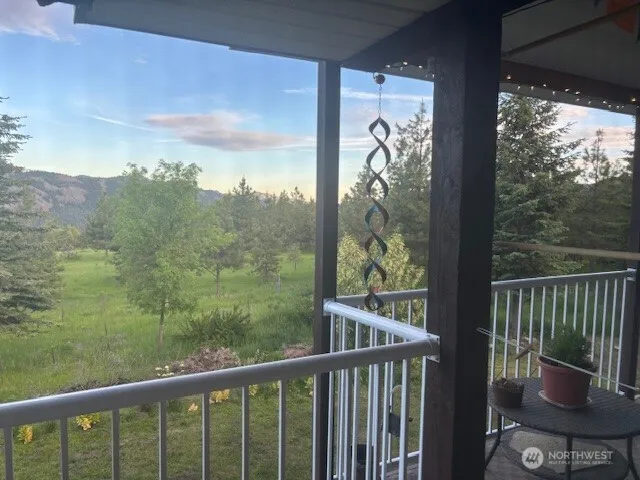 a view of a balcony with chair and wooden floor