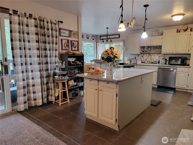a kitchen with kitchen island a sink stove and cabinets
