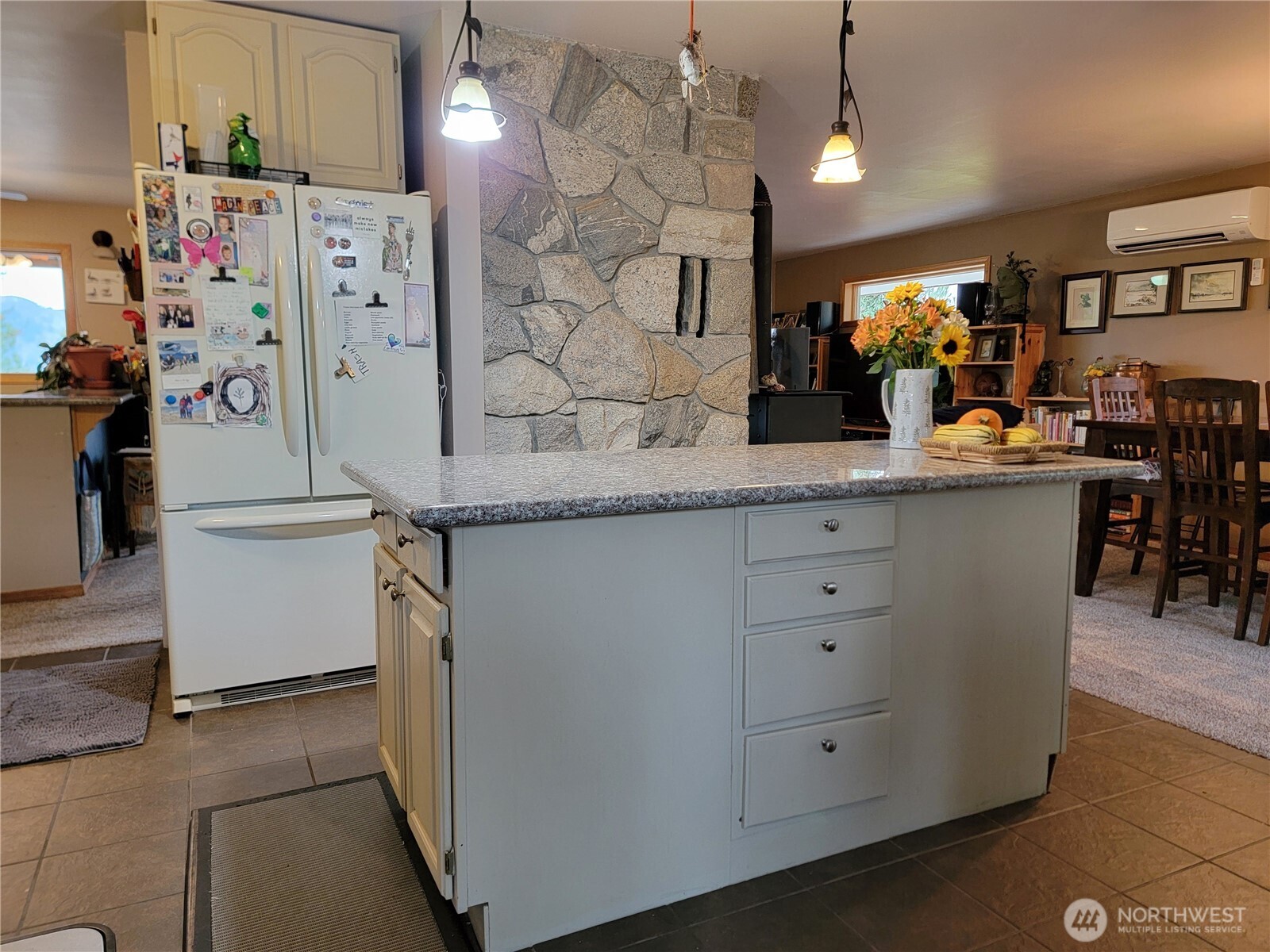 55 Gold Mountain Road Republic, WA 99166 - Photo 5 of 40 a kitchen with stainless steel appliances kitchen island granite countertop a refrigerator a sink dishwasher and white cabinets with wooden floor