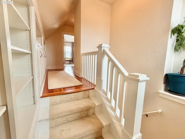 a view of entryway and hall with wooden floor