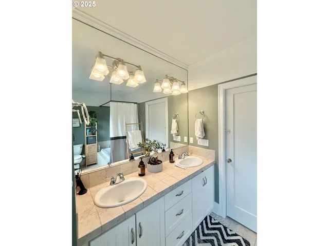 a bathroom with a double vanity sink and mirror