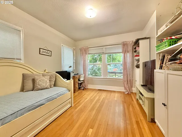 a bedroom with a bed and a large window