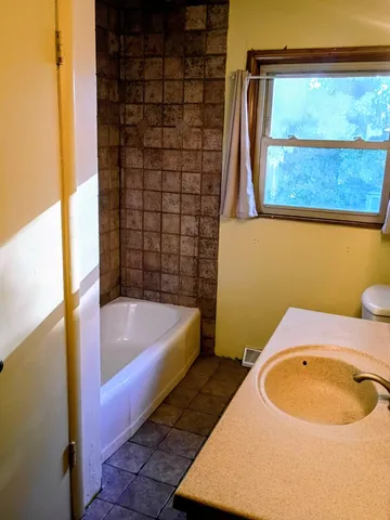 a bathroom with a bathtub and shower
