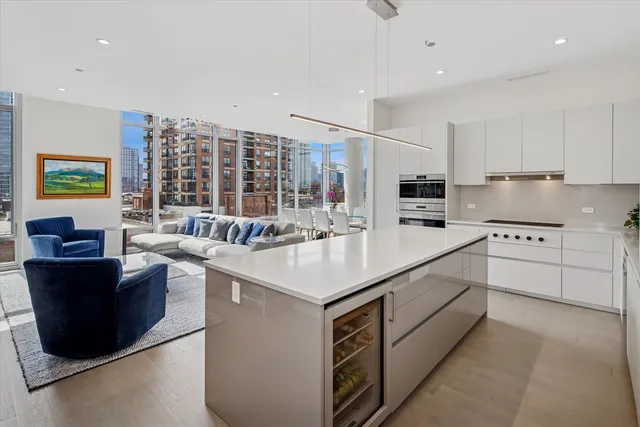 a kitchen with stainless steel appliances kitchen island granite countertop a stove and a sink
