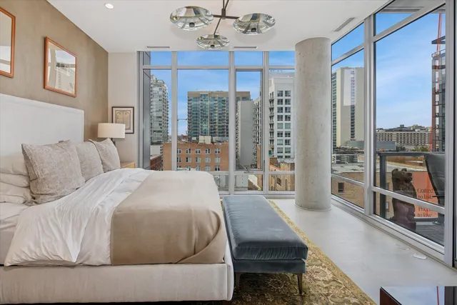 a bedroom with a large bed and a large window