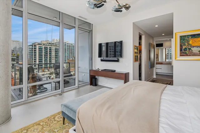 a bedroom with a bed and glass door