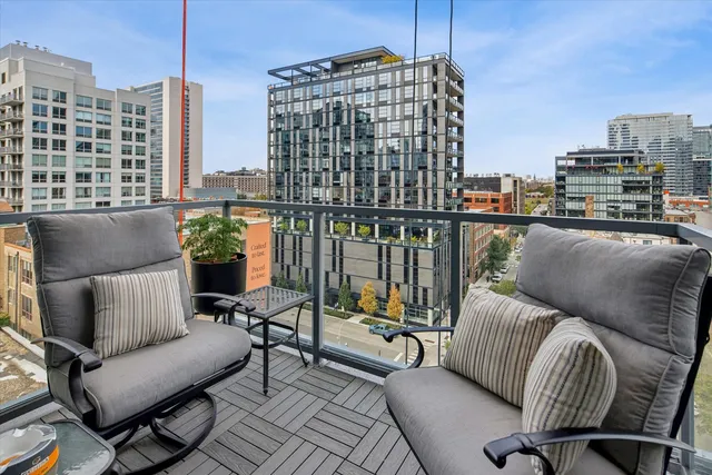 a roof deck with couch and chairs