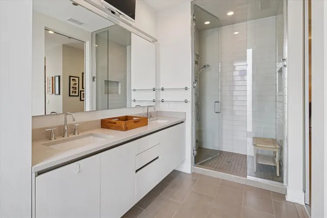 a bathroom with a sink double vanity and a shower
