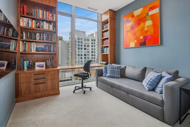 a living room with furniture and a book shelf