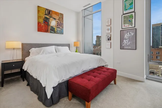 a spacious bedroom with a bed and a cabinets