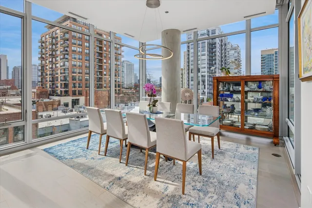 a dining room with furniture a rug and a large window