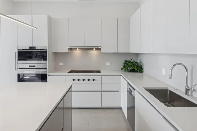 a kitchen with granite countertop white cabinets and white appliances