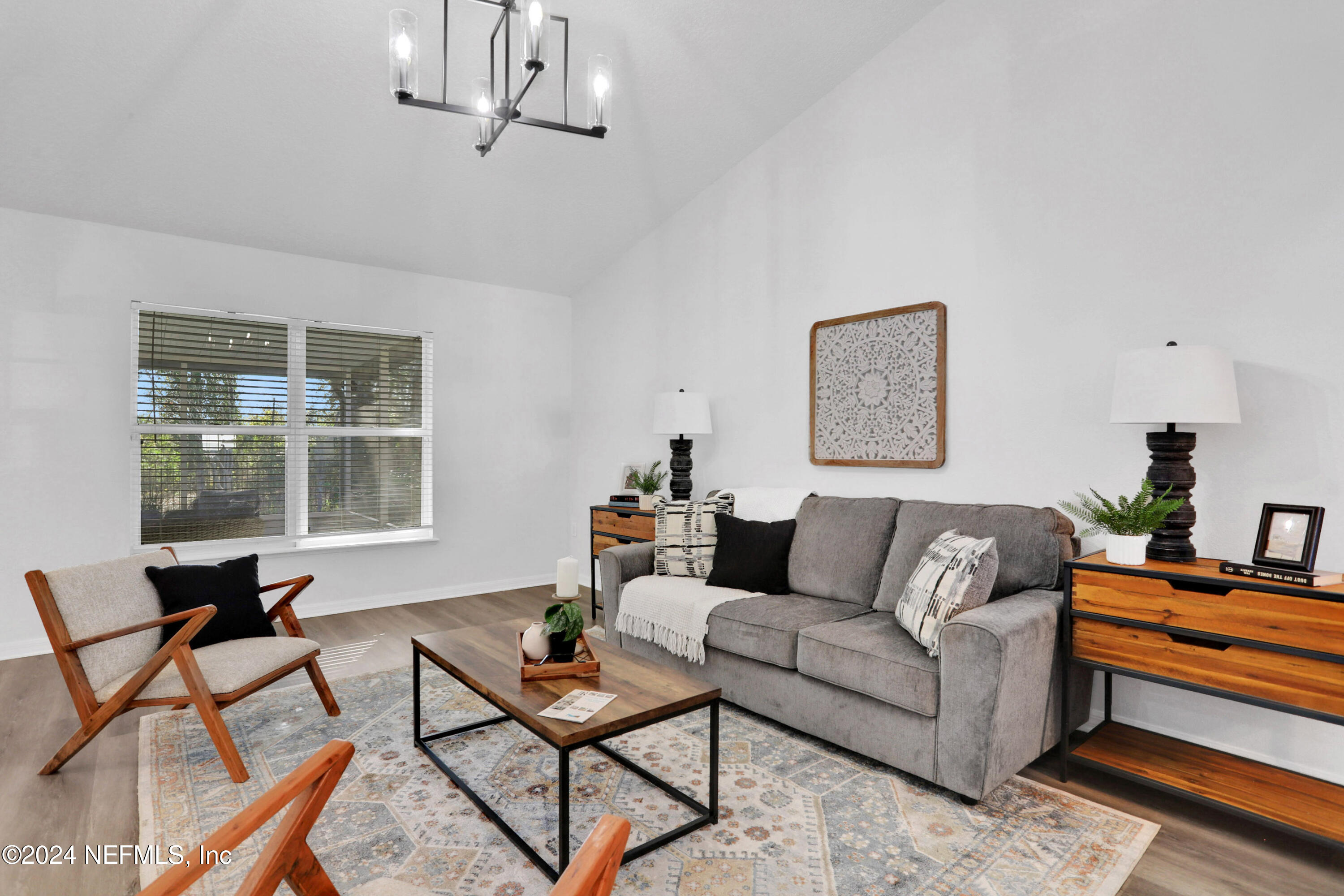 3409 Steelgate Court Middleburg, FL 32068 - Photo 4 of 30 a living room with furniture a window and a chandelier