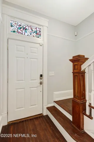 a view of front door with wooden floor