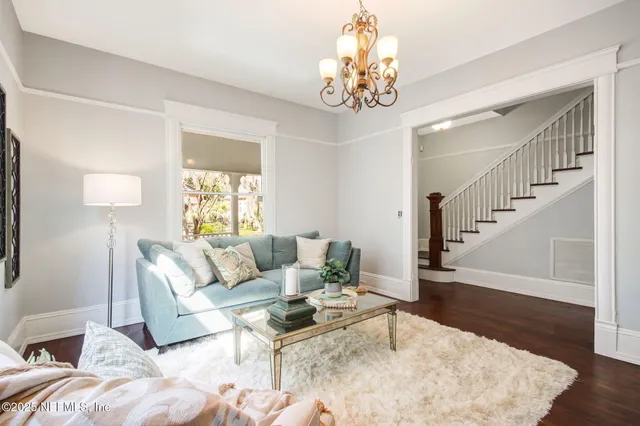 a living room with furniture and a chandelier