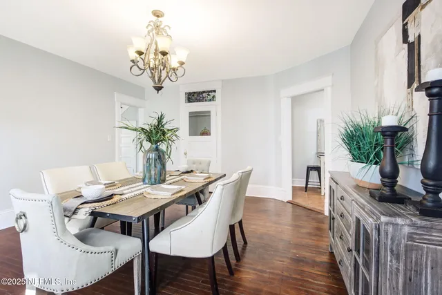 a view of a dining room with furniture wooden floor and chandelier