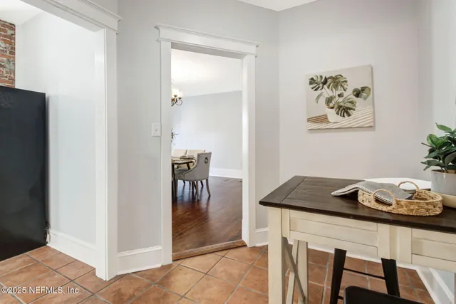 a view of a dining room with furniture and a potted plant