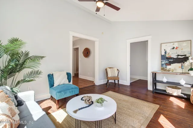 a living room with furniture and wooden floor