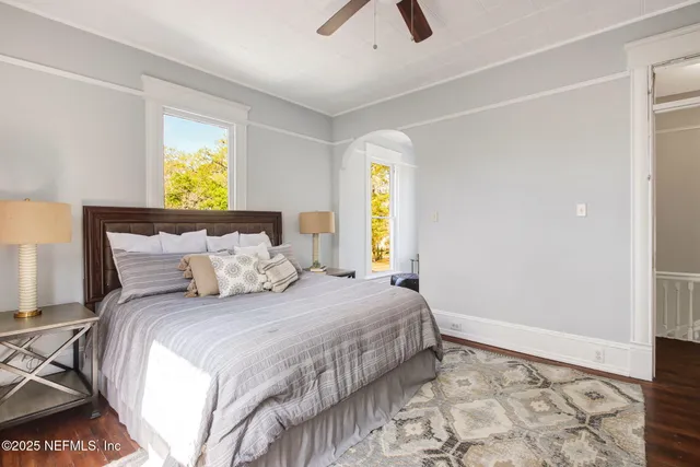 a bedroom with a bed and painting on the wall