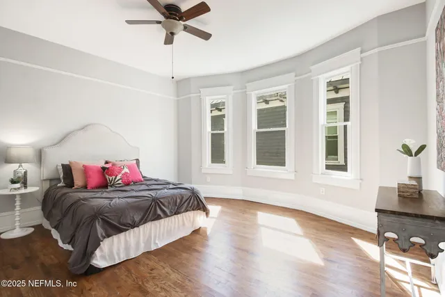 a living room with a bed furniture and a window