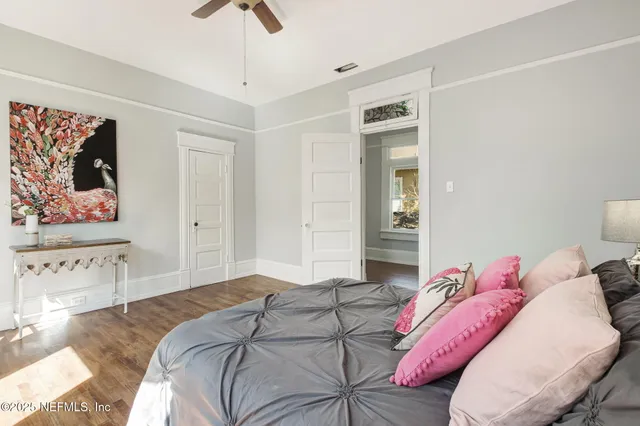 a bedroom with a bed and a painting on the wall