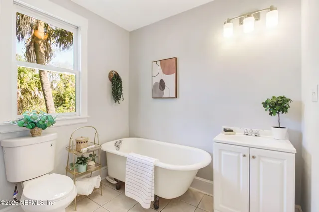 a bathroom with a sink mirror vanity and toilet