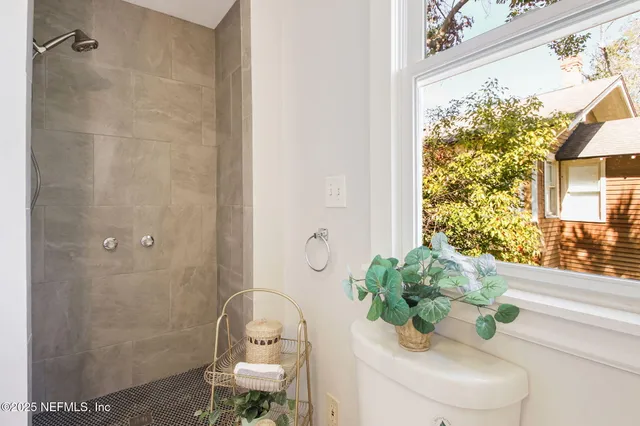 a bathroom with a shower curtain and a window