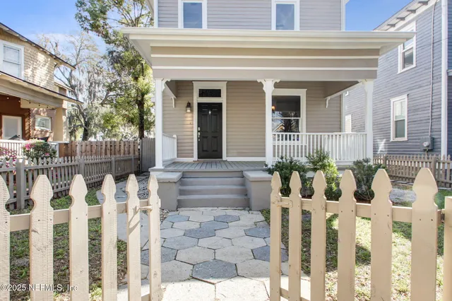a front view of white house with glass windows