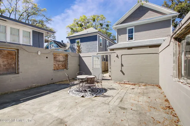 a view of a house with a wooden fence