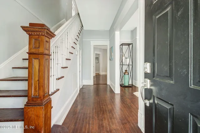 a view of an entryway with wooden floor