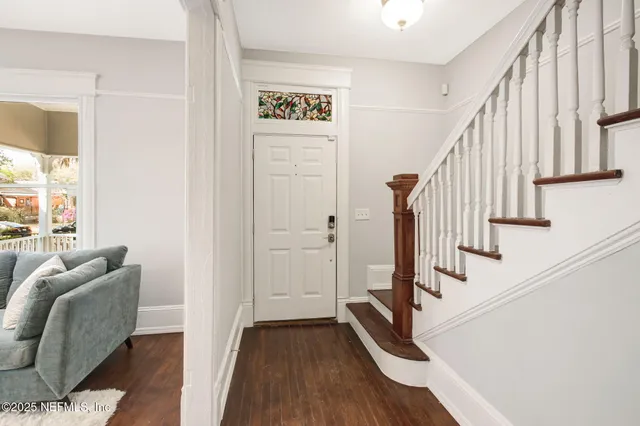 a view of entryway and workspace with wooden floor