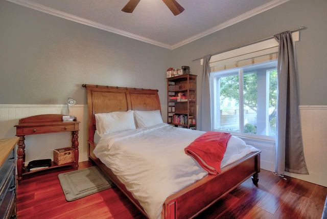 a bed sitting in a bedroom next to a window