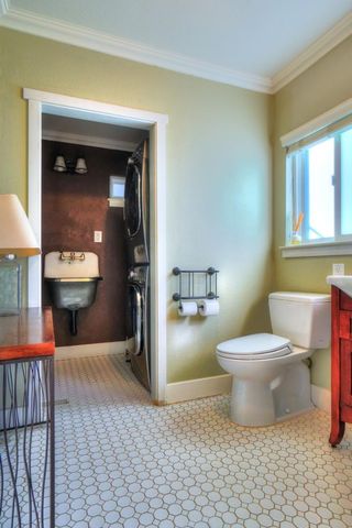 a bathroom with a toilet and a mirror