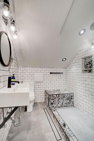 a bathroom with a sink mirror and vanity