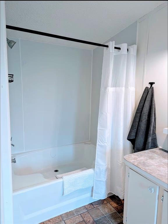 1075 1st Street Hawley, TX 79525 - Photo 11 of 20 a bathroom with a shower and a bathtub