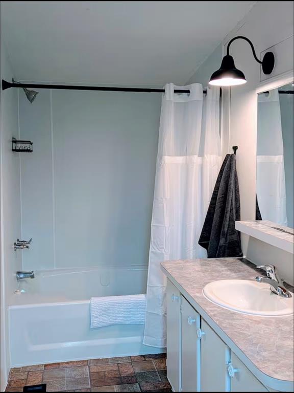 1075 1st Street Hawley, TX 79525 - Photo 12 of 20 a bathroom with a granite countertop sink and a bathtub