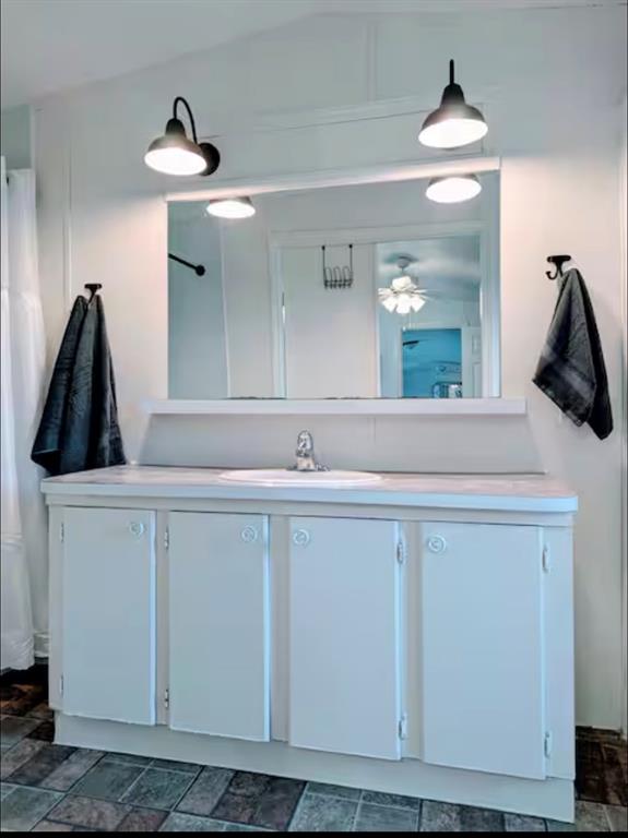 1075 1st Street Hawley, TX 79525 - Photo 13 of 20 a bathroom with a sink and a mirror