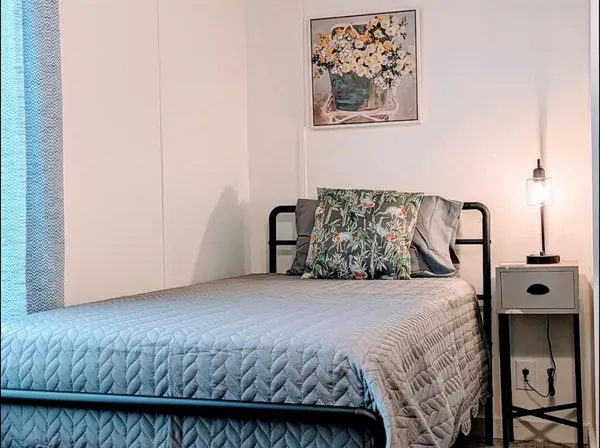 a bedroom with a bed and wall painting