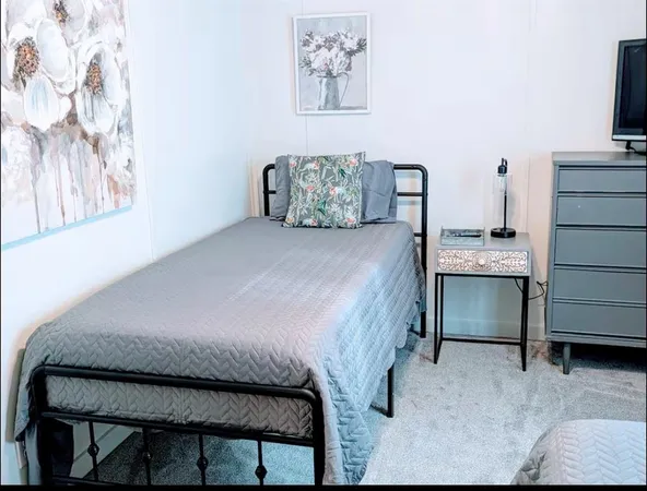 a bedroom with a bed and a television