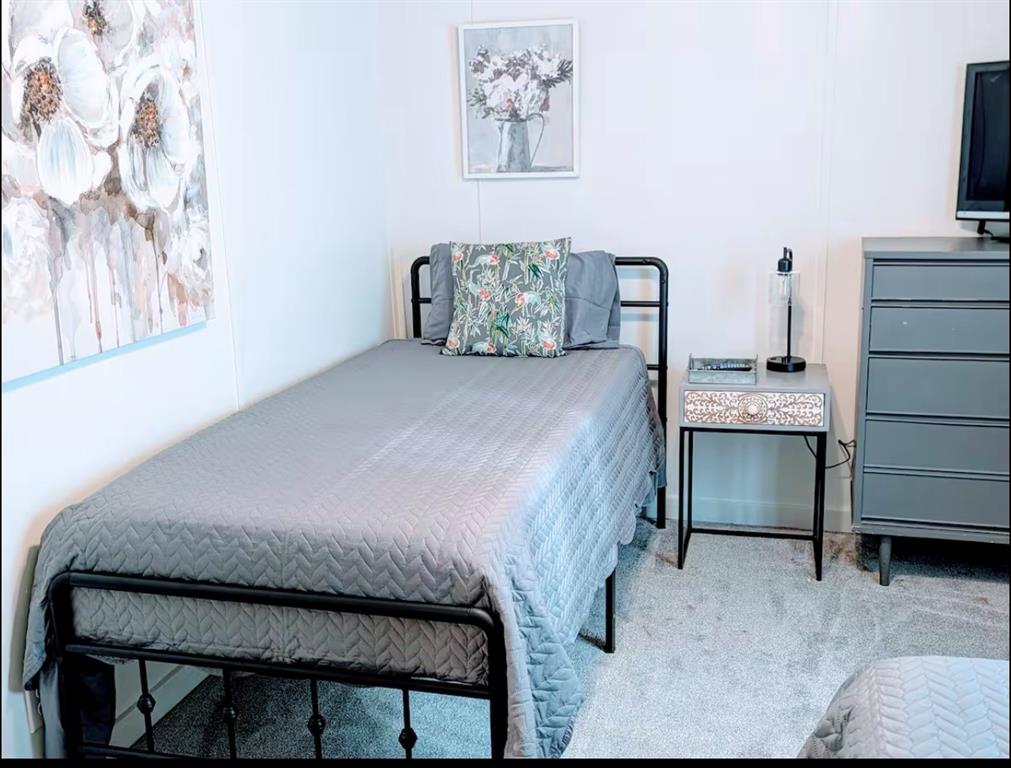 1075 1st Street Hawley, TX 79525 - Photo 15 of 20 a bedroom with a bed and a television