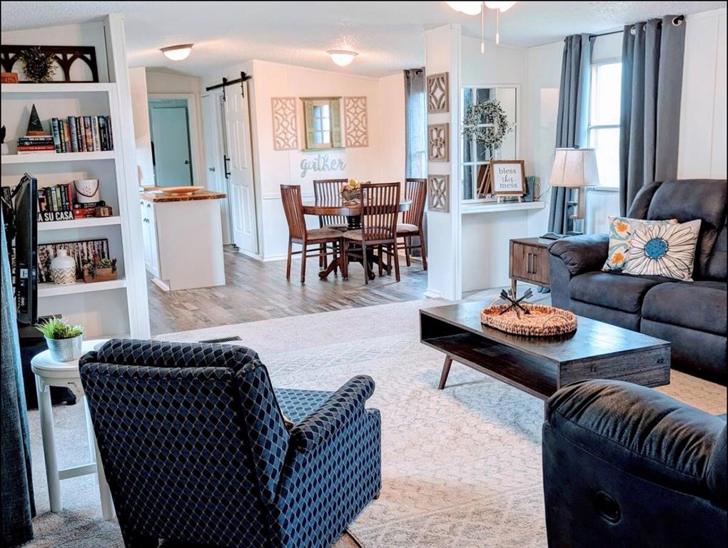 1075 1st Street Hawley, TX 79525 - Photo 6 of 20 a living room with furniture and a book shelf