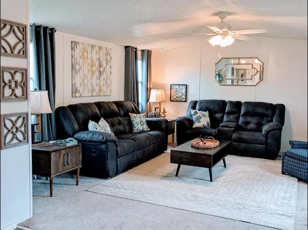 a living room with furniture a rug and a window