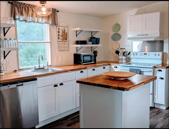 a kitchen with stainless steel appliances granite countertop a sink and a stove